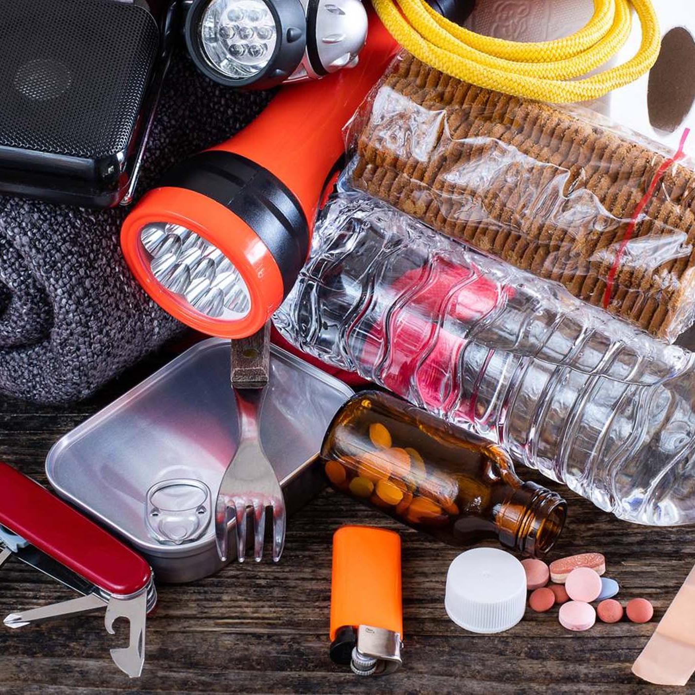 emergency preparedness items scattered on table top